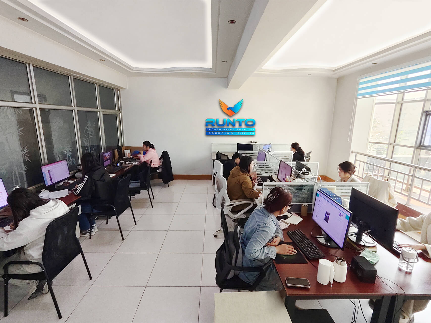 Employees at work in Runtoagent office space, collaborating and focused on their tasks.
